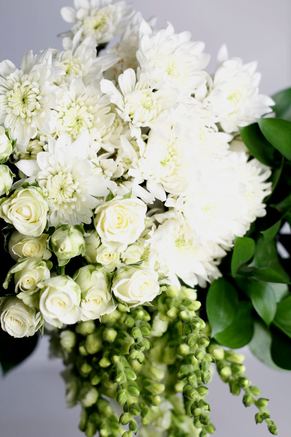 Hand Tie Bouquet in White colored Theme. (  the specific types of flowers may vary based on seasonal availability.)